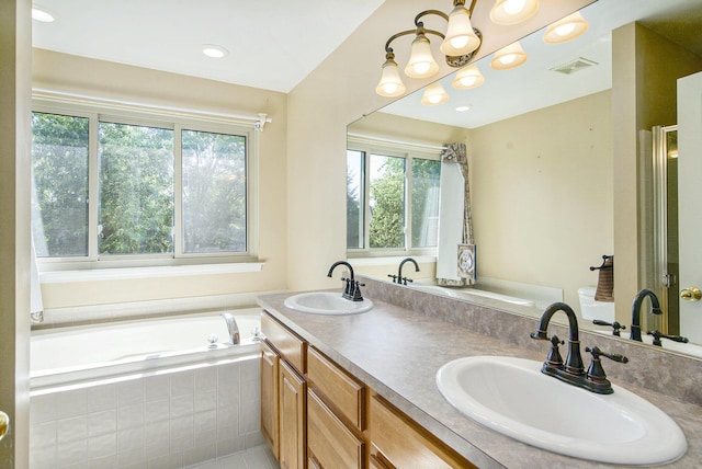 7269 Wellington Ln, Ypsilanti, MI 48197 - bathroom with healthy amount of natural light, a garden tub, double vanity, and recessed lighting