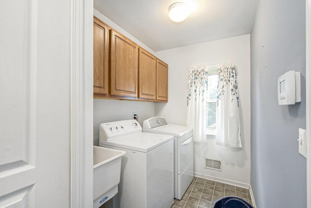 7269 Wellington Ln, Ypsilanti, MI 48197 - laundry area with independent washer and dryer, cabinet space, and tile patterned floors