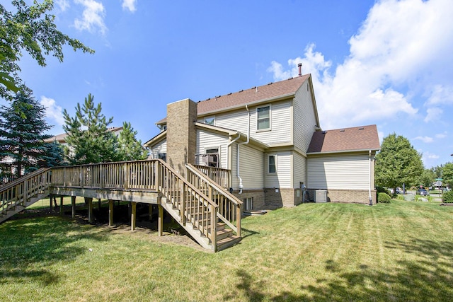 7269 Wellington Ln, Ypsilanti, MI 48197 - rear view of house with stairway, a deck, and a lawn
