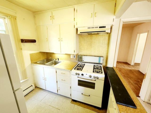 214 S Gorham St, Jackson, MI 49203 - kitchen featuring white appliances, under cabinet range hood, baseboard heating, backsplash, and white cabinets