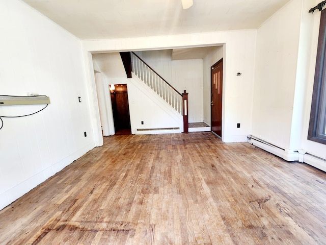 214 S Gorham St, Jackson, MI 49203 - spare room with wood-type flooring, stairway, and baseboard heating