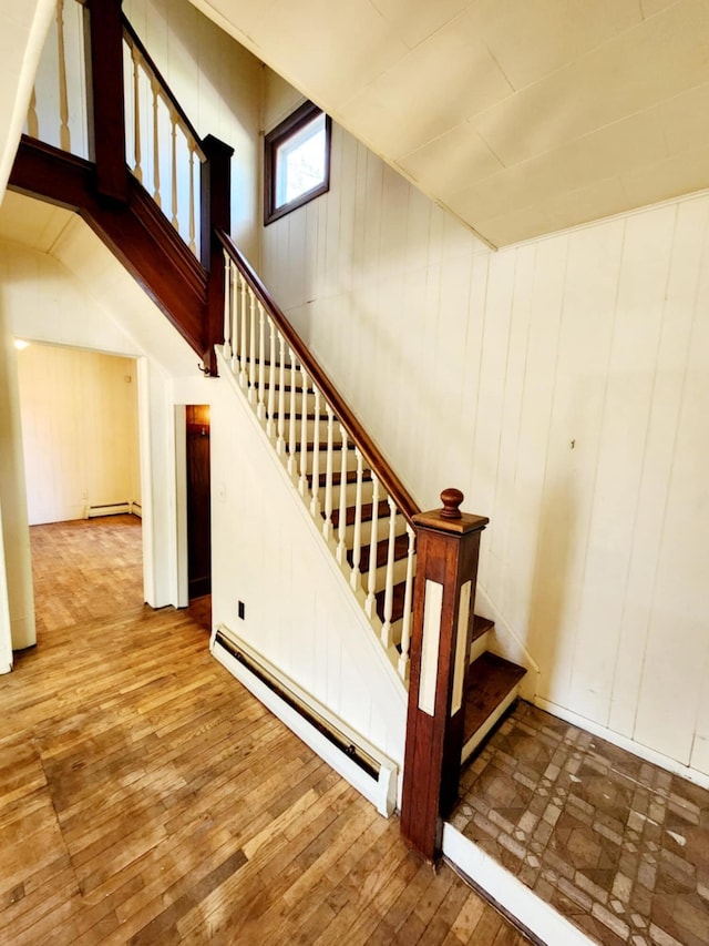 214 S Gorham St, Jackson, MI 49203 - stairway with a baseboard radiator, wood-type flooring, and wooden walls