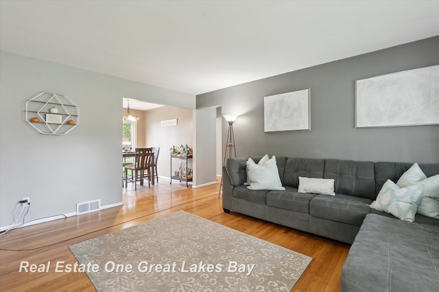 2270 Anderson Rd, Saginaw, MI 48603 - living room featuring wood finished floors and a chandelier