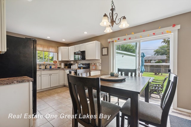 2270 Anderson Rd, Saginaw, MI 48603 - dining room featuring light tile patterned floors, a chandelier, and recessed lighting