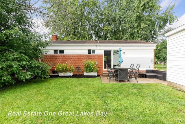 2270 Anderson Rd, Saginaw, MI 48603 - rear view of property featuring a patio, brick siding, a chimney, a yard, and outdoor lounge area