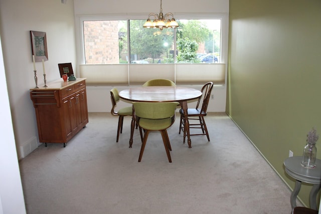 1265 S Maple Rd Unit 207, Ann Arbor, MI 48103 - dining area featuring light carpet and a chandelier
