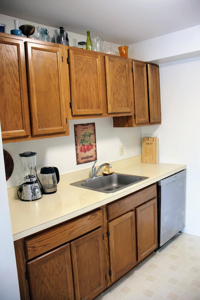 1265 S Maple Rd Unit 207, Ann Arbor, MI 48103 - kitchen with stainless steel dishwasher, light countertops, and brown cabinetry