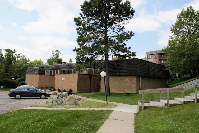 1265 S Maple Rd Unit 207, Ann Arbor, MI 48103 - view of building exterior with uncovered parking