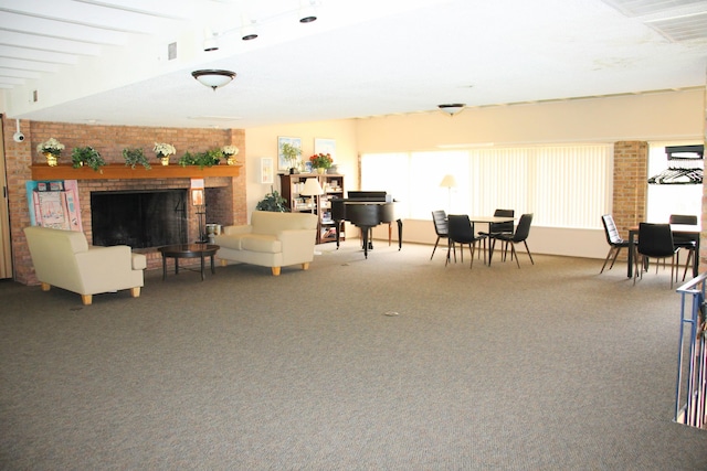1265 S Maple Rd Unit 207, Ann Arbor, MI 48103 - living area with plenty of natural light, a brick fireplace, and carpet