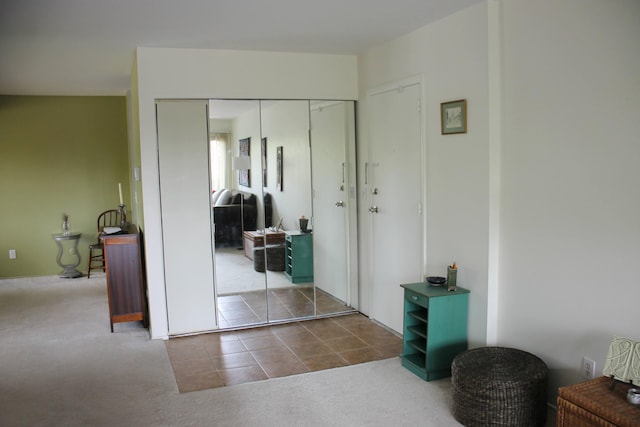 1265 S Maple Rd Unit 207, Ann Arbor, MI 48103 - carpeted bedroom featuring a closet and tile patterned flooring