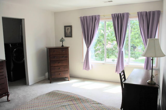 1265 S Maple Rd Unit 207, Ann Arbor, MI 48103 - bedroom featuring washer / dryer, carpet, and multiple windows