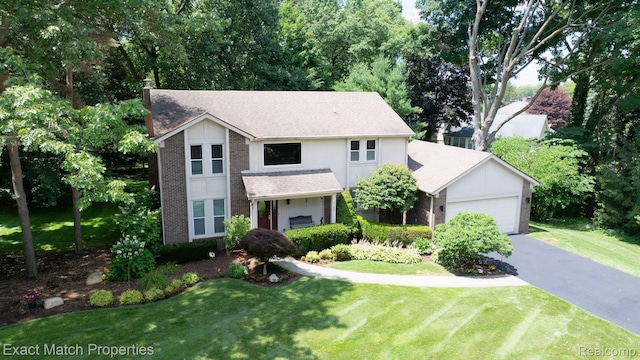 3742 Hearthstone Dr, Commerce Twp, MI 48382 - traditional-style house with brick siding, an attached garage, a front lawn, and a shingled roof