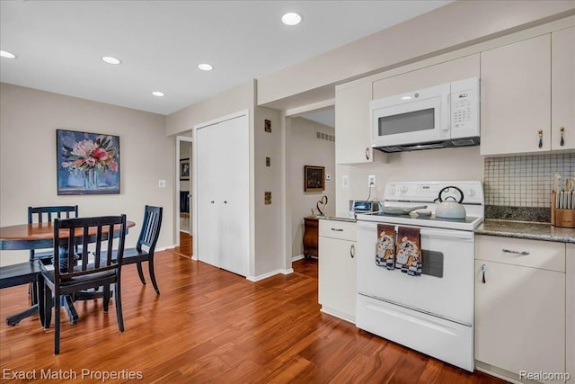 3742 Hearthstone Dr, Commerce Twp, MI 48382 - kitchen featuring white appliances, wood finished floors, backsplash, recessed lighting, and white cabinetry