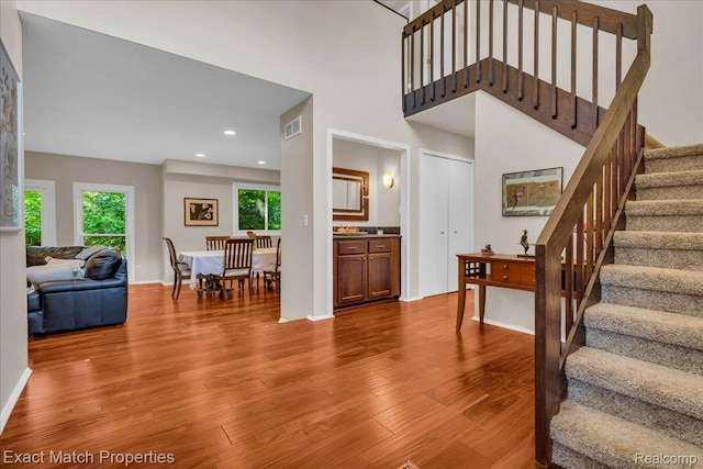 3742 Hearthstone Dr, Commerce Twp, MI 48382 - stairway with plenty of natural light, wood finished floors, recessed lighting, and a towering ceiling