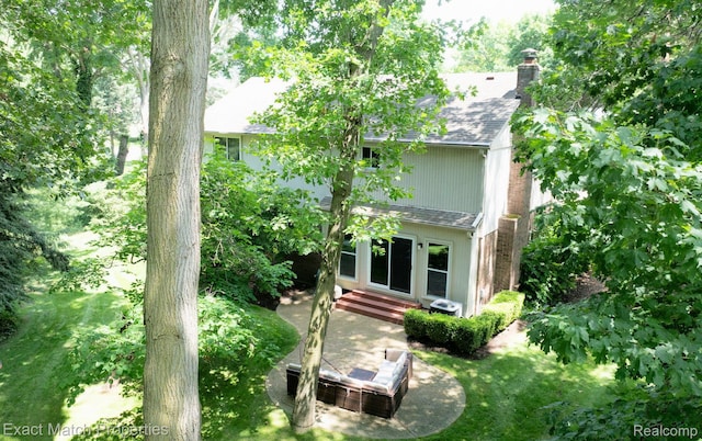 3742 Hearthstone Dr, Commerce Twp, MI 48382 - back of house with entry steps, a chimney, and roof with shingles
