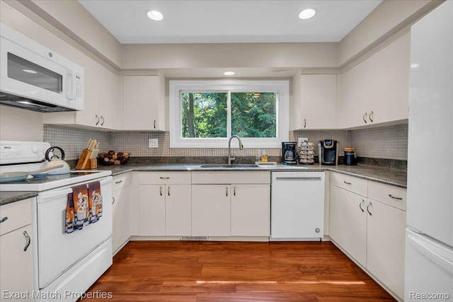 3742 Hearthstone Dr, Commerce Twp, MI 48382 - kitchen featuring white appliances, white cabinetry, dark countertops, backsplash, and recessed lighting