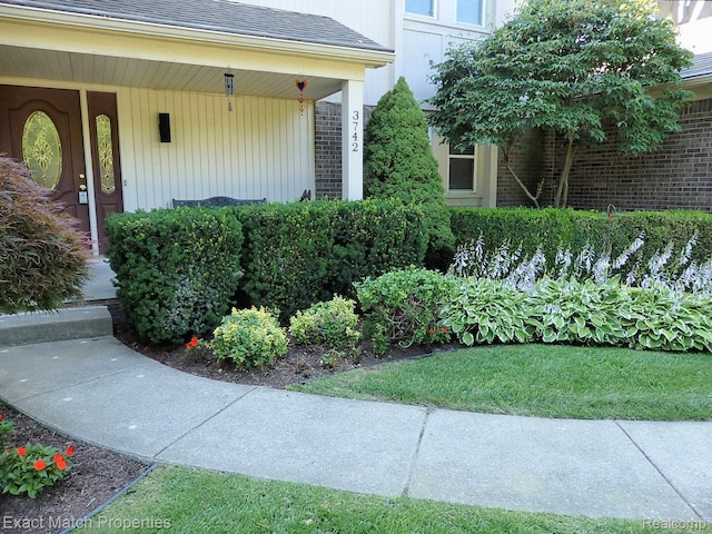 3742 Hearthstone Dr, Commerce Twp, MI 48382 - property entrance with a shingled roof, a porch, and brick siding