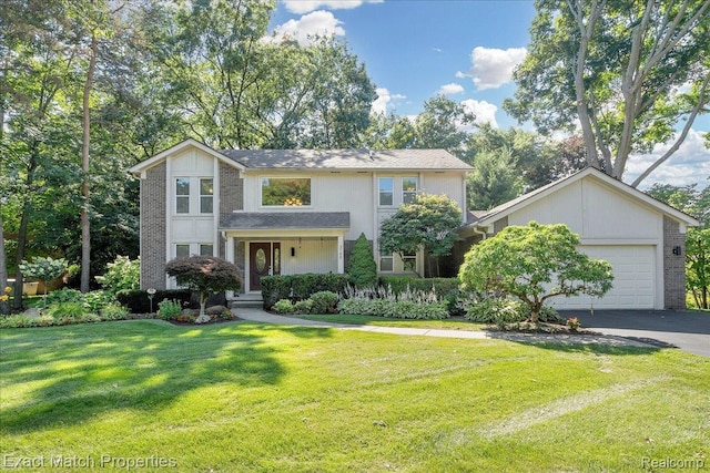 3742 Hearthstone Dr, Commerce Twp, MI 48382 - traditional-style home featuring brick siding, a garage, driveway, and a front yard