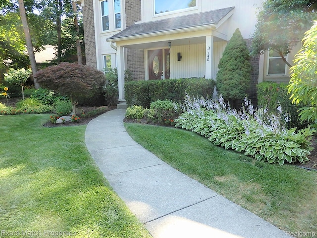 3742 Hearthstone Dr, Commerce Twp, MI 48382 - property entrance with brick siding, a lawn, and roof with shingles