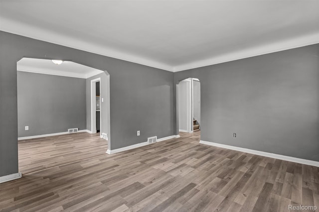 17631 Kentfield St, Detroit, MI 48219 - spare room with arched walkways, wood finished floors, and ornamental molding
