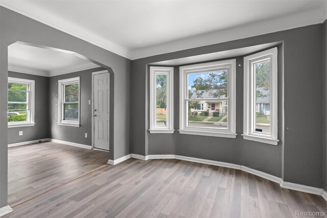 17631 Kentfield St, Detroit, MI 48219 - unfurnished room with wood finished floors, arched walkways, and crown molding