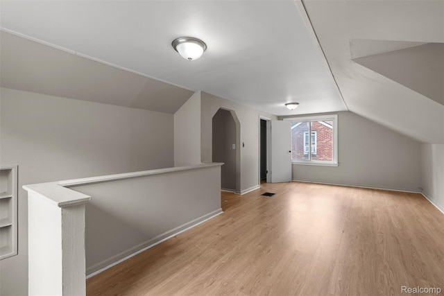 17631 Kentfield St, Detroit, MI 48219 - additional living space with arched walkways, light wood finished floors, and lofted ceiling