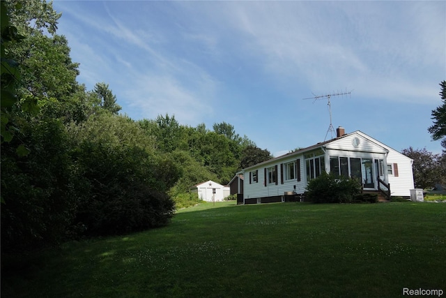 1295 Hadley Rd, Lapeer, MI 48446 - view of side of property featuring a chimney and a yard