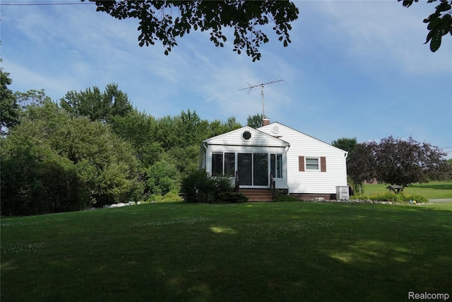 1295 Hadley Rd, Lapeer, MI 48446 - back of house with entry steps, a lawn, and a chimney