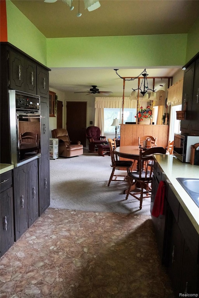 1295 Hadley Rd, Lapeer, MI 48446 - kitchen featuring black oven, stainless steel microwave, a ceiling fan, and light countertops