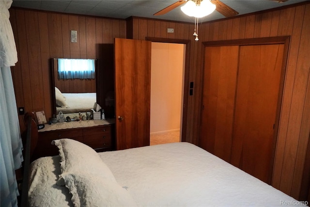 1295 Hadley Rd, Lapeer, MI 48446 - bedroom featuring wood walls, a closet, and a ceiling fan