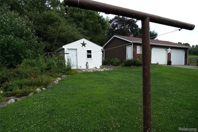 1295 Hadley Rd, Lapeer, MI 48446 - view of green lawn featuring an outdoor structure and a detached garage