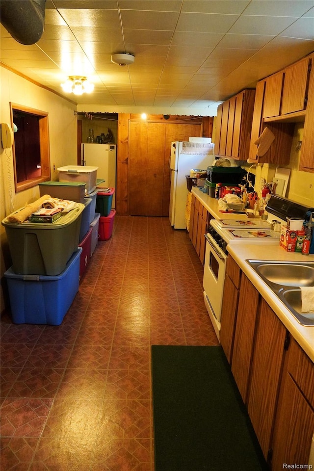 1295 Hadley Rd, Lapeer, MI 48446 - kitchen with white appliances, light countertops, and brown cabinets
