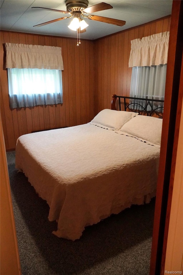 1295 Hadley Rd, Lapeer, MI 48446 - bedroom with carpet floors, wood walls, and ceiling fan