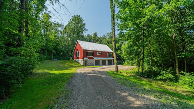 2816 Niles Buchanan Rd, Buchanan, MI 49107 - rustic home with driveway, a garage, a metal roof, a front yard, and stone siding