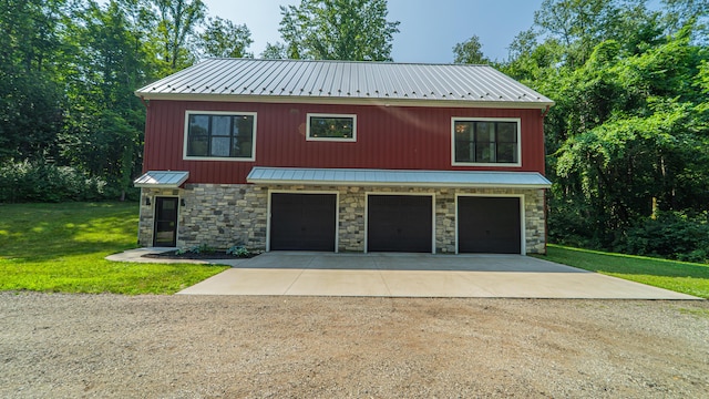 2816 Niles Buchanan Rd, Buchanan, MI 49107 - view of front of house with stone siding, driveway, an attached garage, and a metal roof