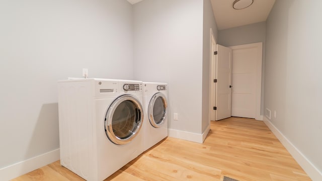 2816 Niles Buchanan Rd, Buchanan, MI 49107 - laundry area featuring washer and dryer and light wood-type flooring
