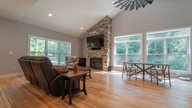 2816 Niles Buchanan Rd, Buchanan, MI 49107 - living area featuring light wood finished floors, high vaulted ceiling, a fireplace, and recessed lighting
