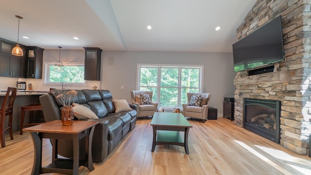 2816 Niles Buchanan Rd, Buchanan, MI 49107 - living room with vaulted ceiling, a stone fireplace, light wood-style flooring, and recessed lighting