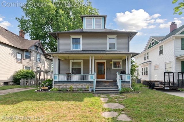 305 E 6th St, Monroe, MI 48161 - american foursquare style home featuring a porch and a front lawn