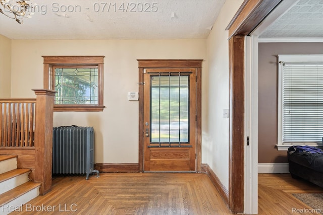 305 E 6th St, Monroe, MI 48161 - foyer entrance featuring radiator and stairs