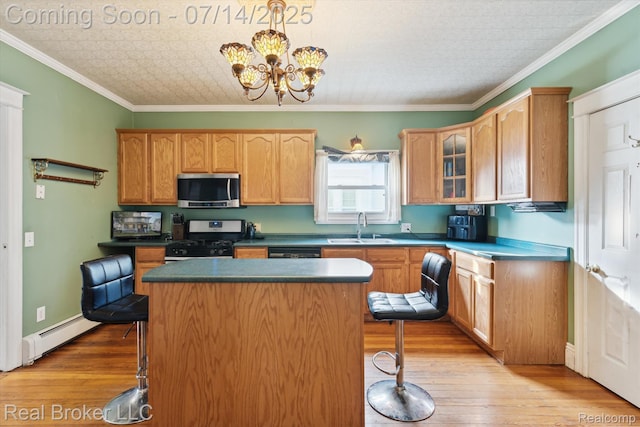 305 E 6th St, Monroe, MI 48161 - kitchen featuring appliances with stainless steel finishes, a baseboard radiator, a breakfast bar, light wood-type flooring, and an ornate ceiling