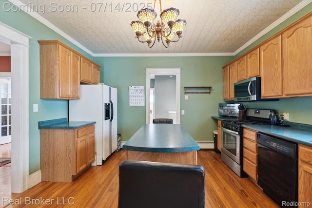 305 E 6th St, Monroe, MI 48161 - kitchen featuring stainless steel appliances, an ornate ceiling, dark countertops, wood finished floors, and a chandelier