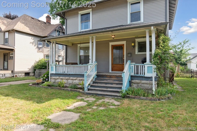 305 E 6th St, Monroe, MI 48161 - american foursquare style home featuring a porch and a front lawn