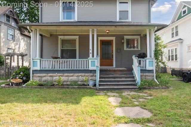305 E 6th St, Monroe, MI 48161 - traditional style home featuring covered porch and a front lawn