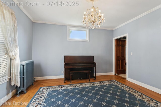 305 E 6th St, Monroe, MI 48161 - living area with radiator heating unit, a chandelier, wood finished floors, and ornamental molding