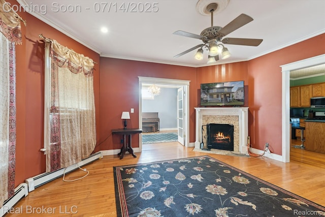305 E 6th St, Monroe, MI 48161 - living room featuring wood-type flooring, a fireplace with flush hearth, ornamental molding, ceiling fan, and baseboard heating