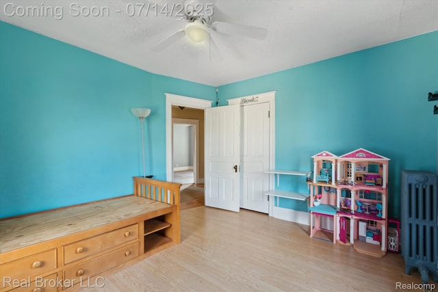 305 E 6th St, Monroe, MI 48161 - bedroom with wood finished floors, a ceiling fan, and a textured ceiling
