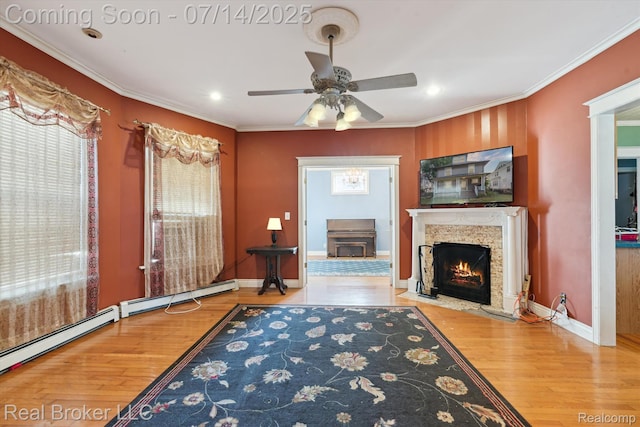 305 E 6th St, Monroe, MI 48161 - unfurnished living room featuring baseboard heating, wood finished floors, a ceiling fan, recessed lighting, and crown molding