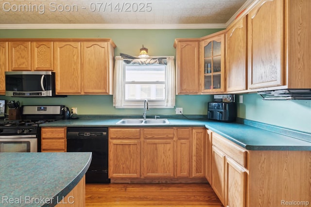 305 E 6th St, Monroe, MI 48161 - kitchen with stainless steel appliances, light wood-style floors, glass insert cabinets, and dark countertops