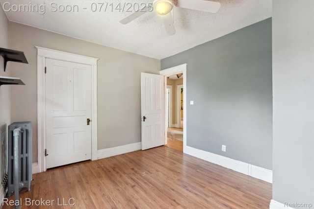 305 E 6th St, Monroe, MI 48161 - unfurnished bedroom featuring radiator, wood finished floors, and ceiling fan
